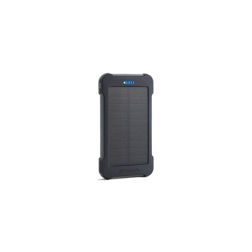 The Patriot Power Cell CX portable solar power bank, a rugged grey rectangular unit with a solar panel on the face and a row of charge level indicator lights